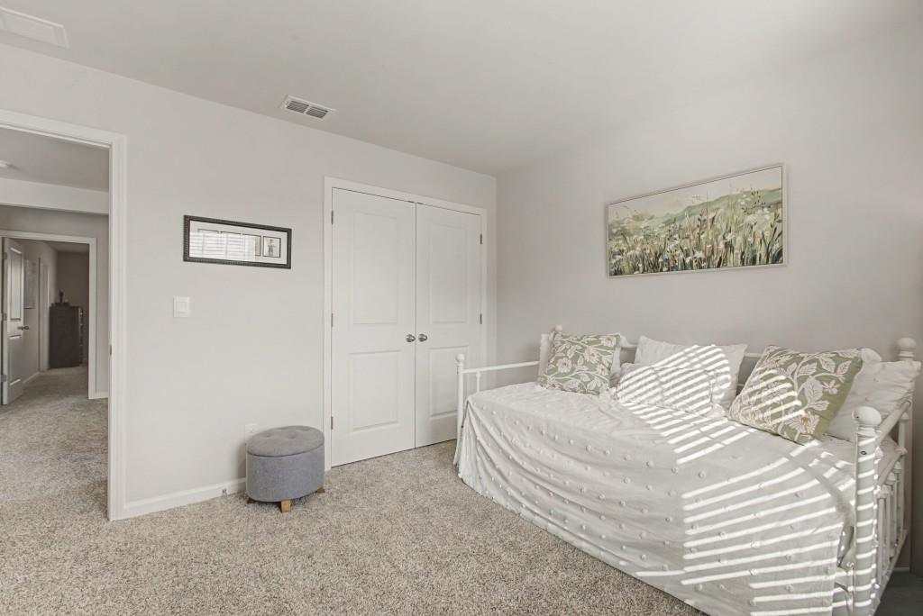 87 Cranson Walk Pendergrass, GA 30567 - Photo 35 of 50 a bedroom with a bed and a painting on the wall