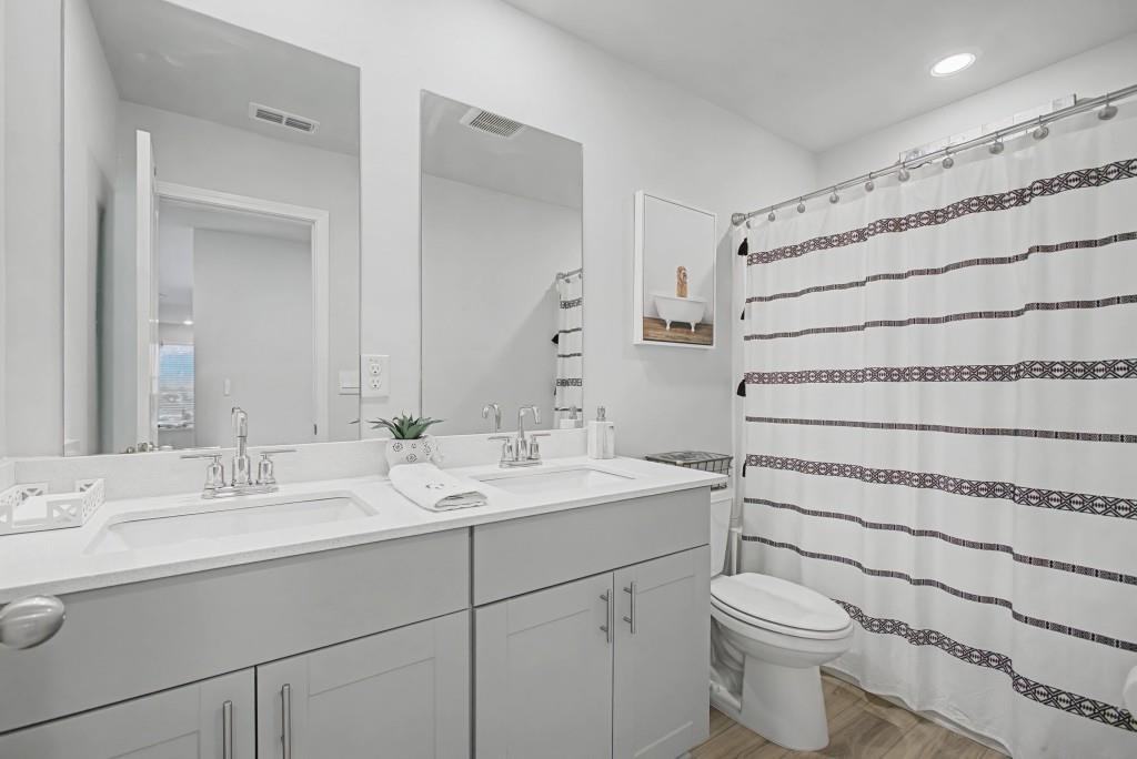 87 Cranson Walk Pendergrass, GA 30567 - Photo 38 of 50 a bathroom with a double vanity sink mirror and toilet