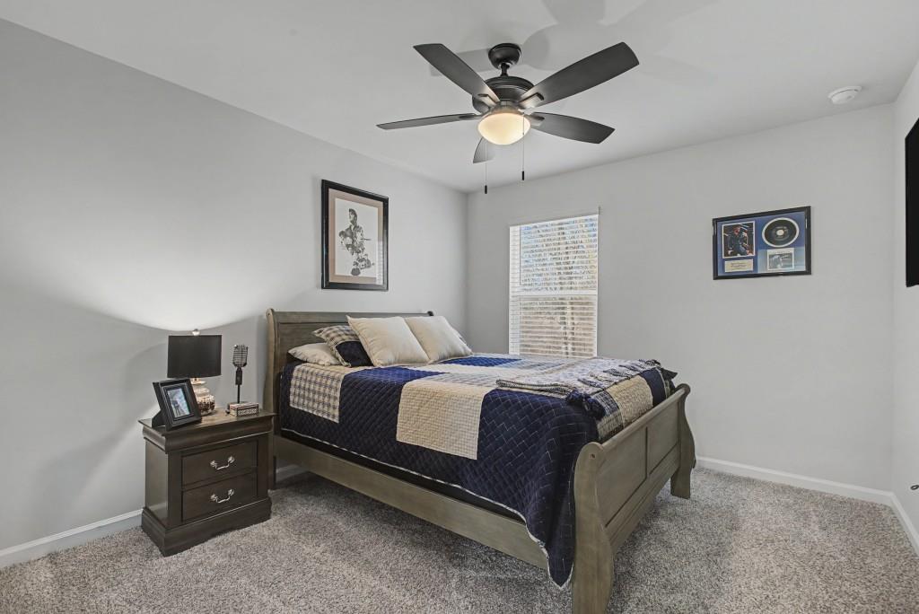 87 Cranson Walk Pendergrass, GA 30567 - Photo 40 of 50 a bed room with a bed and a ceiling fan