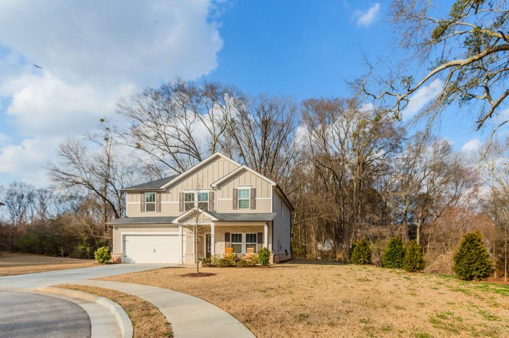 87 Cranson Walk Pendergrass, GA 30567 - Photo 4 of 50 a front view of a house with a yard covered in snow