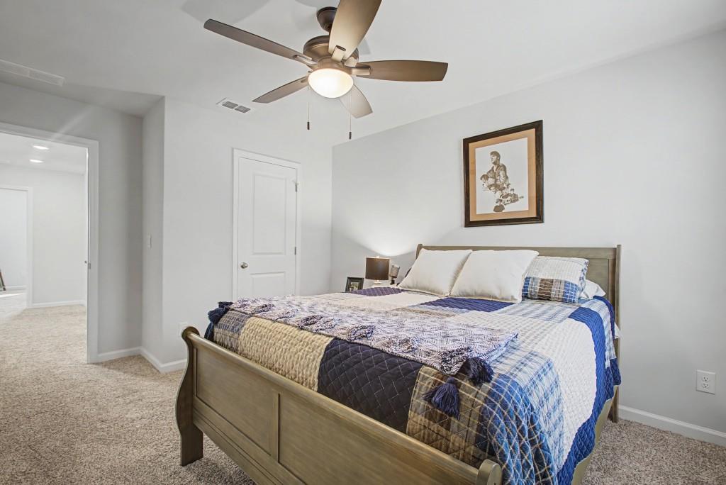 87 Cranson Walk Pendergrass, GA 30567 - Photo 41 of 50 a bedroom with a bed and a ceiling fan