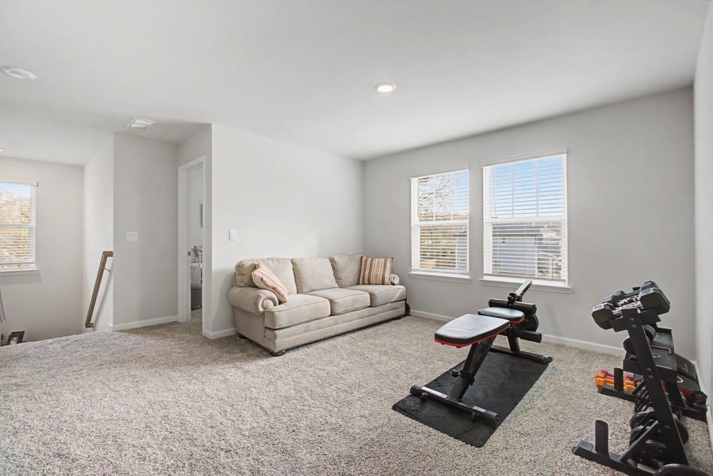 87 Cranson Walk Pendergrass, GA 30567 - Photo 42 of 50 a living room with furniture a window and gym equipment
