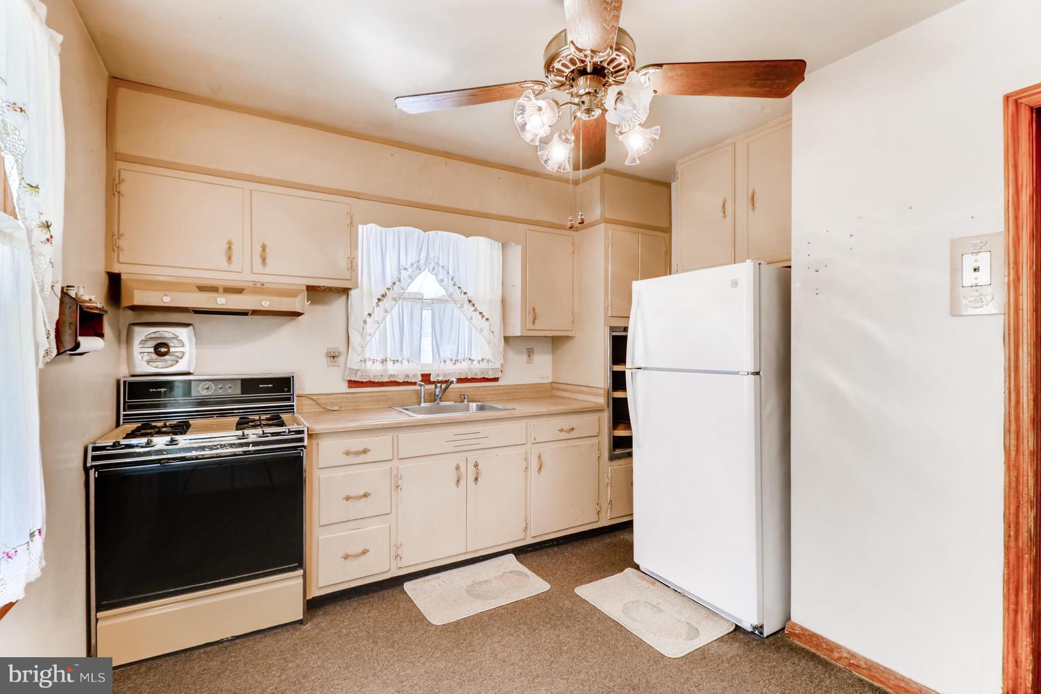 7510 Harmans Road Harmans, MD 21077 - Photo 2 of 11 a kitchen with appliances a sink and a refrigerator