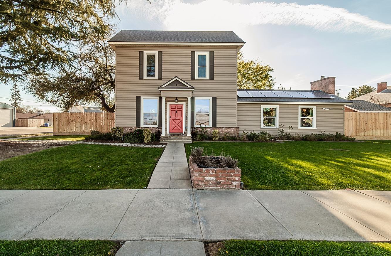 a front view of house with yard and green space