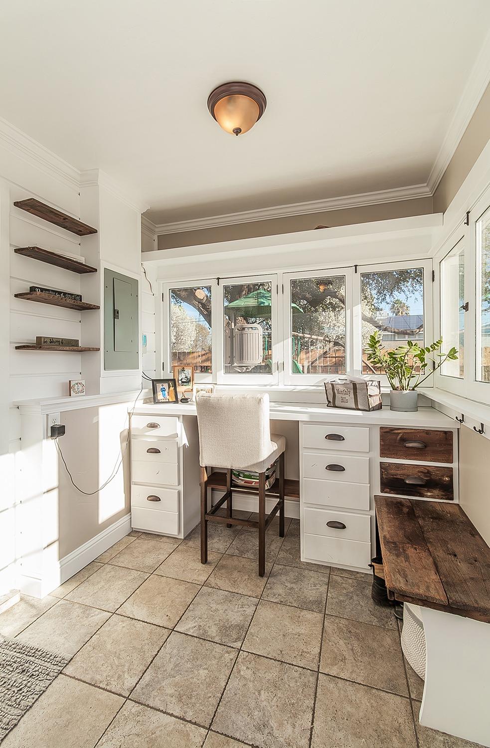 1053 K Street Reedley, CA 93654 - Photo 17 of 62 a kitchen that has a lot of cabinets in it and a window