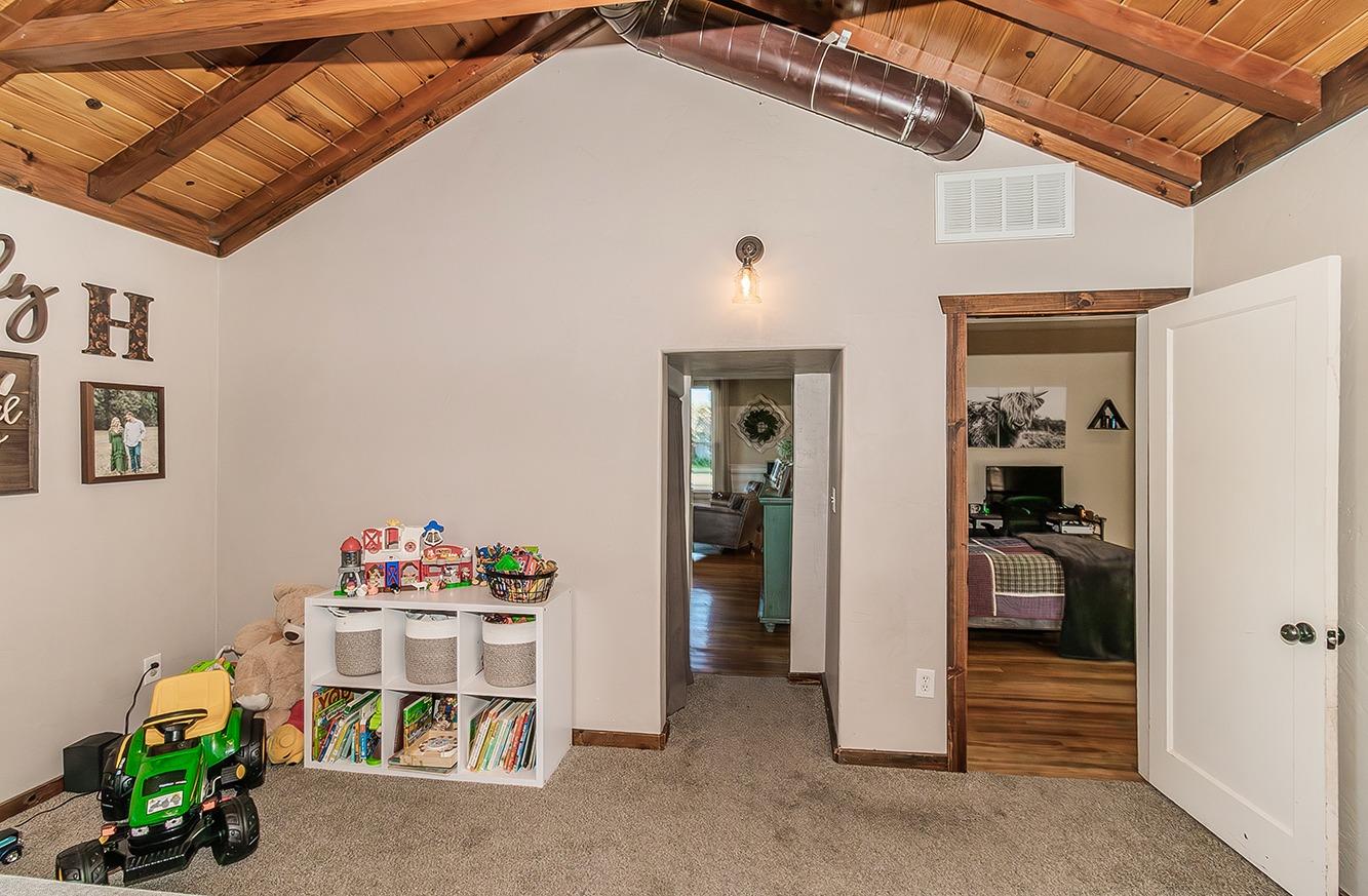 1053 K Street Reedley, CA 93654 - Photo 23 of 62 a view of a hallway with dining room and wooden shelves