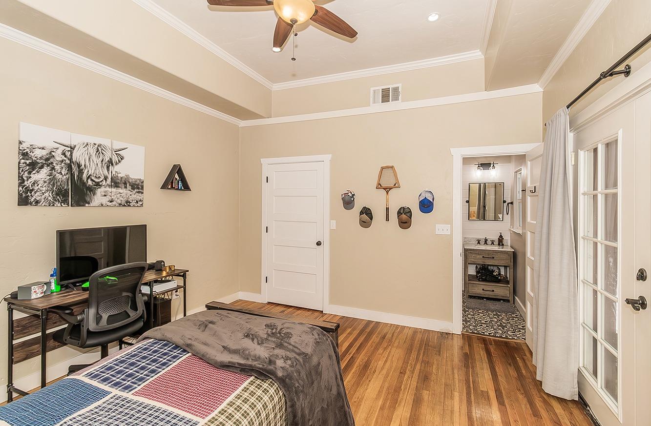 1053 K Street Reedley, CA 93654 - Photo 25 of 62 a bedroom with a bed and a fireplace