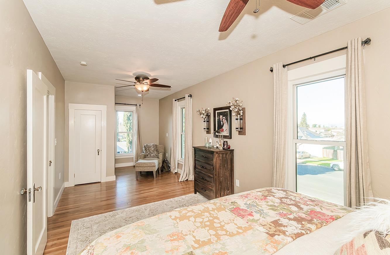 1053 K Street Reedley, CA 93654 - Photo 31 of 62 a bedroom with a bed and a chandelier