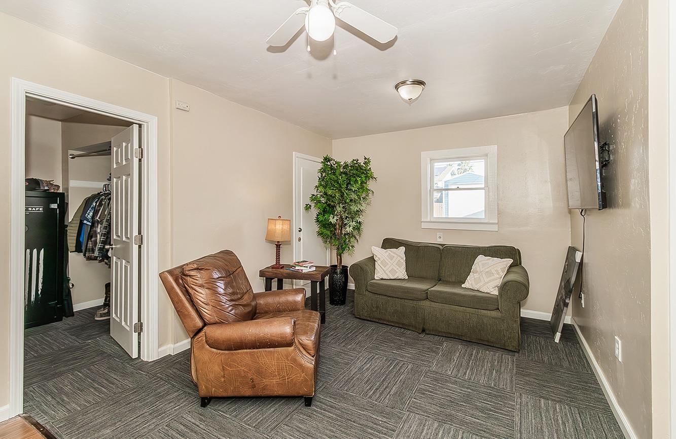 1053 K Street Reedley, CA 93654 - Photo 53 of 62 a living room with furniture and a flat screen tv