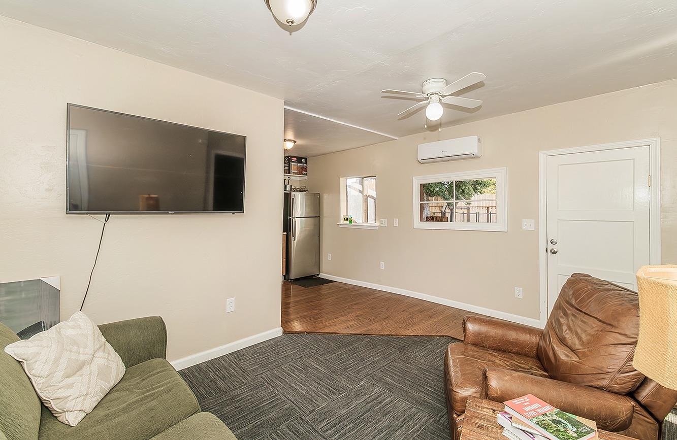1053 K Street Reedley, CA 93654 - Photo 54 of 62 a living room with furniture and a flat screen tv