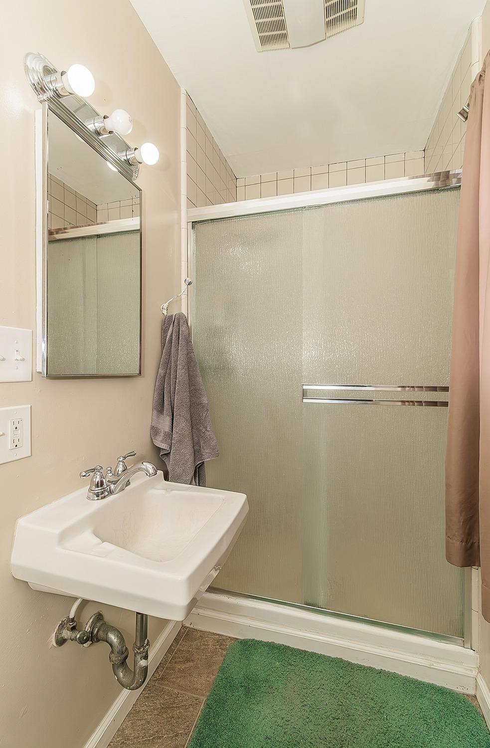 1053 K Street Reedley, CA 93654 - Photo 58 of 62 a bathroom with a sink and a mirror