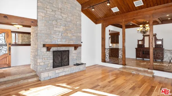 a large kitchen with a large window and stainless steel appliances
