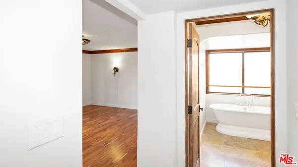 a view of a hallway with wooden floor