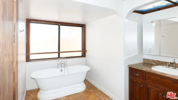 a view of a livingroom with wooden floor and a fireplace