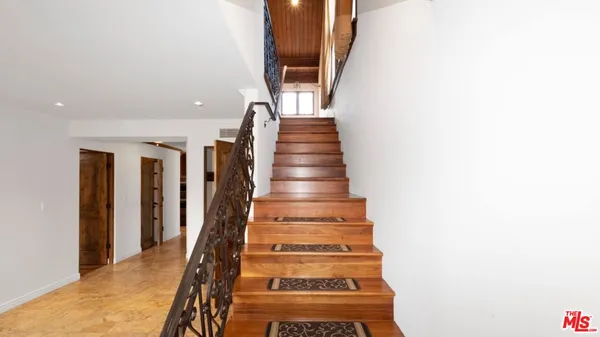 a big room with wooden floor and windows