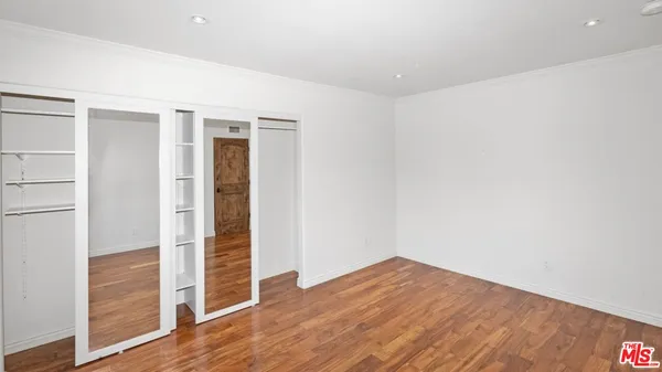 a view of walk in closet with empty racks