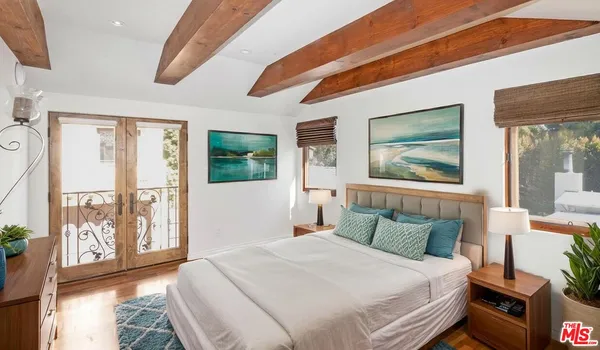 a view of a swimming pool with outdoor seating and plants