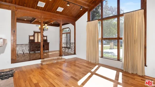 a view of an entryway with wooden floor and a fireplace