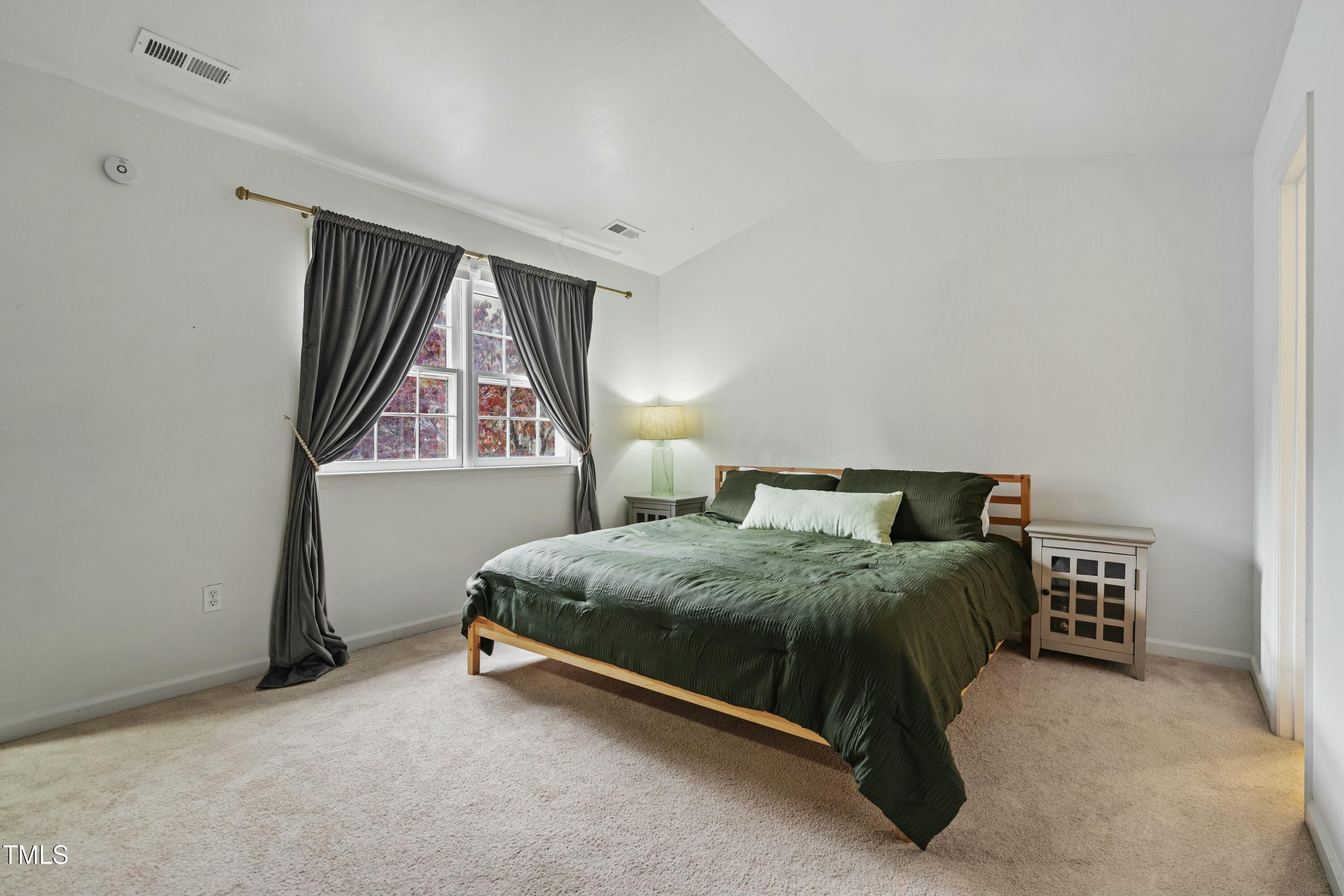 126 Shady Spring Place Durham, NC 27713 - Photo 6 of 14 a spacious bedroom with a bed and window