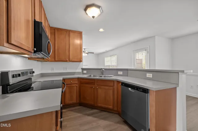 a kitchen with a sink cabinets and window
