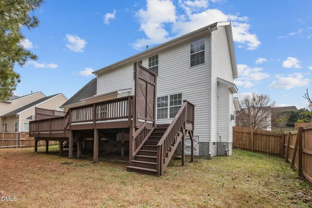 a view of backyard with wooden fence