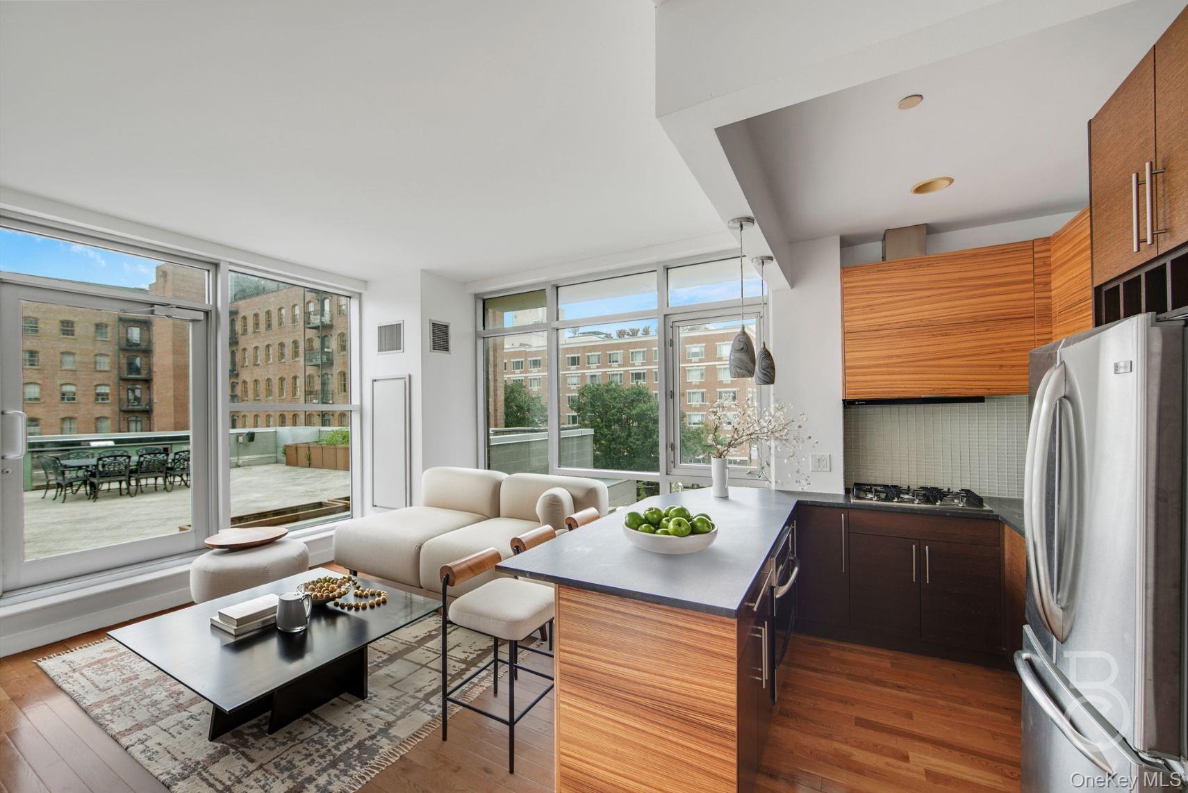 a living room with furniture and a refrigerator