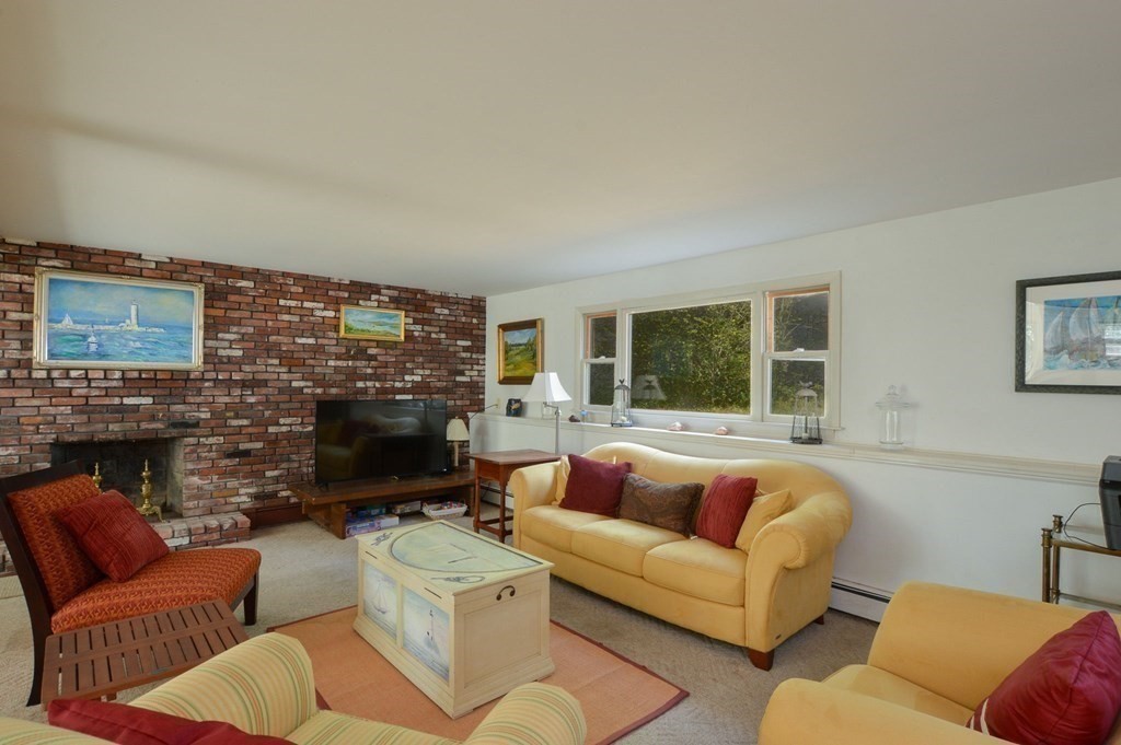 230 Pimlico Pond Road Mashpee, MA 02649 - Photo 12 of 35 a living room with furniture a fireplace and a flat screen tv