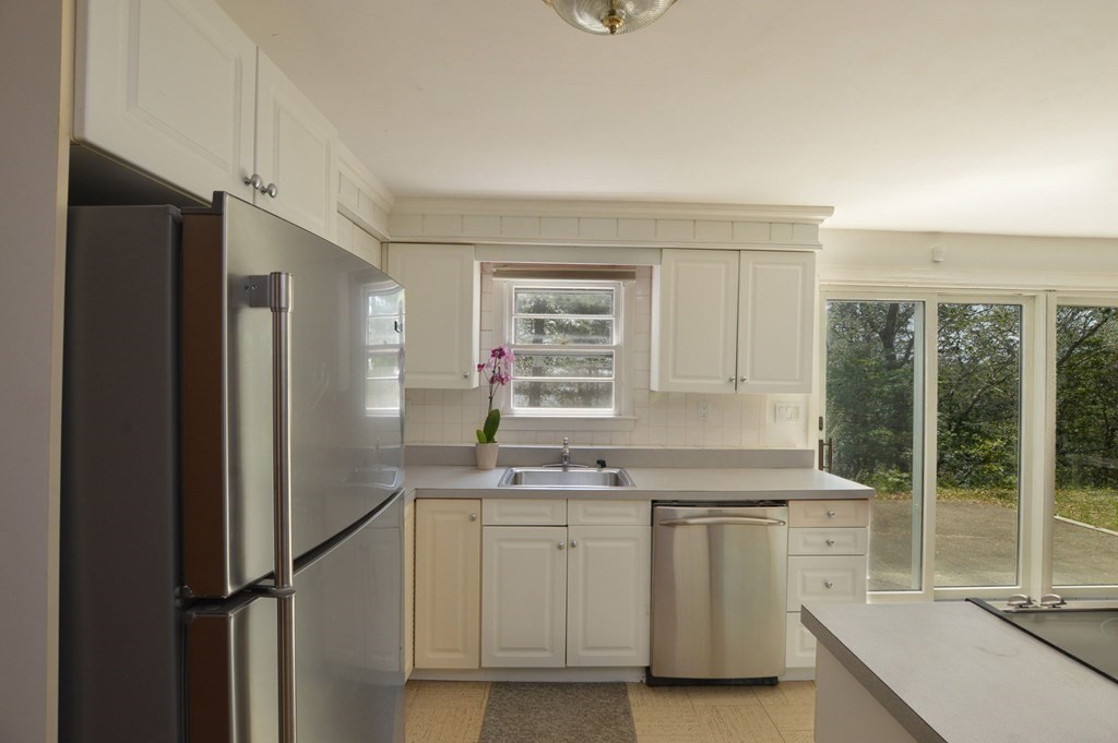 230 Pimlico Pond Road Mashpee, MA 02649 - Photo 15 of 35 a kitchen with white cabinets and white appliances