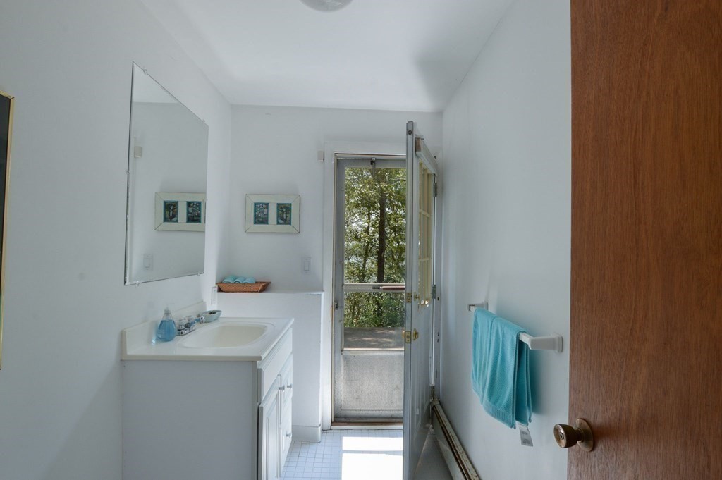 230 Pimlico Pond Road Mashpee, MA 02649 - Photo 18 of 35 a bathroom with a sink and mirror with bathtub