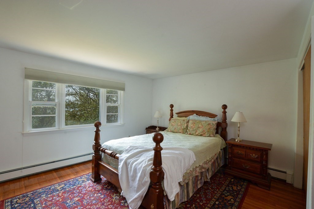 230 Pimlico Pond Road Mashpee, MA 02649 - Photo 22 of 35 a bed sitting in a bedroom next to a window