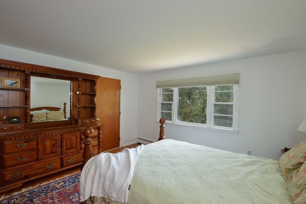 230 Pimlico Pond Road Mashpee, MA 02649 - Photo 23 of 35 a bedroom with a bed and wooden floor
