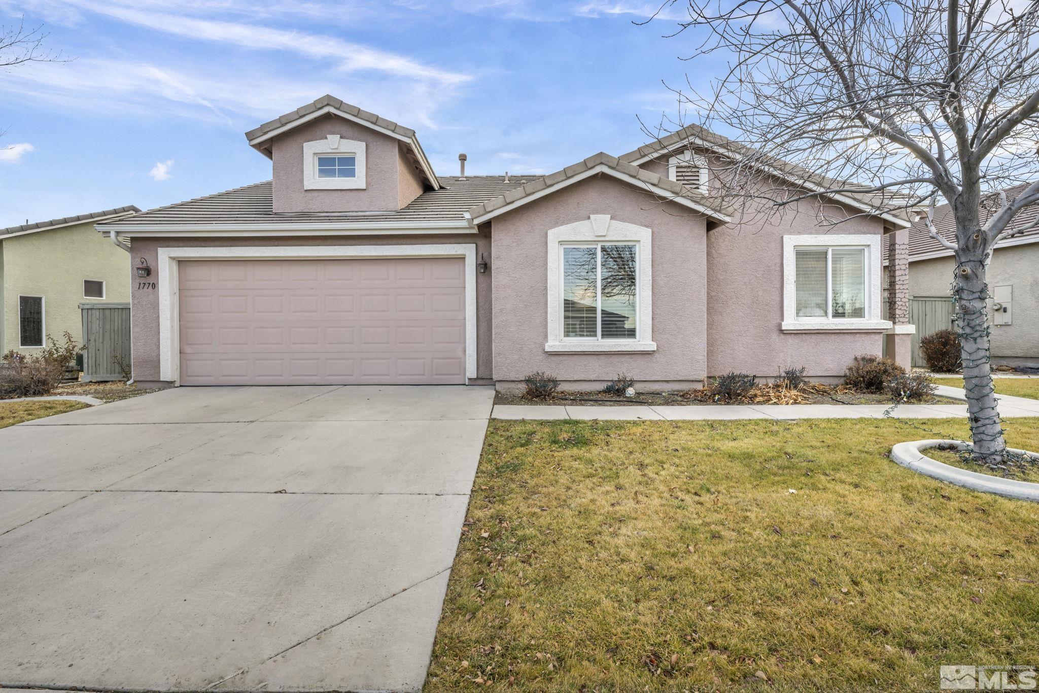 1770 Ornellaia Way Reno, NV 89521 - Photo 1 of 37 a view of a white house with a yard and large tree