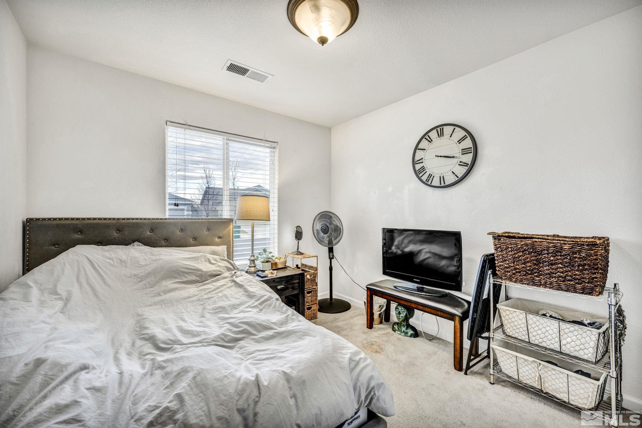 1770 Ornellaia Way Reno, NV 89521 - Photo 11 of 37 a bedroom with a bed and a chandelier