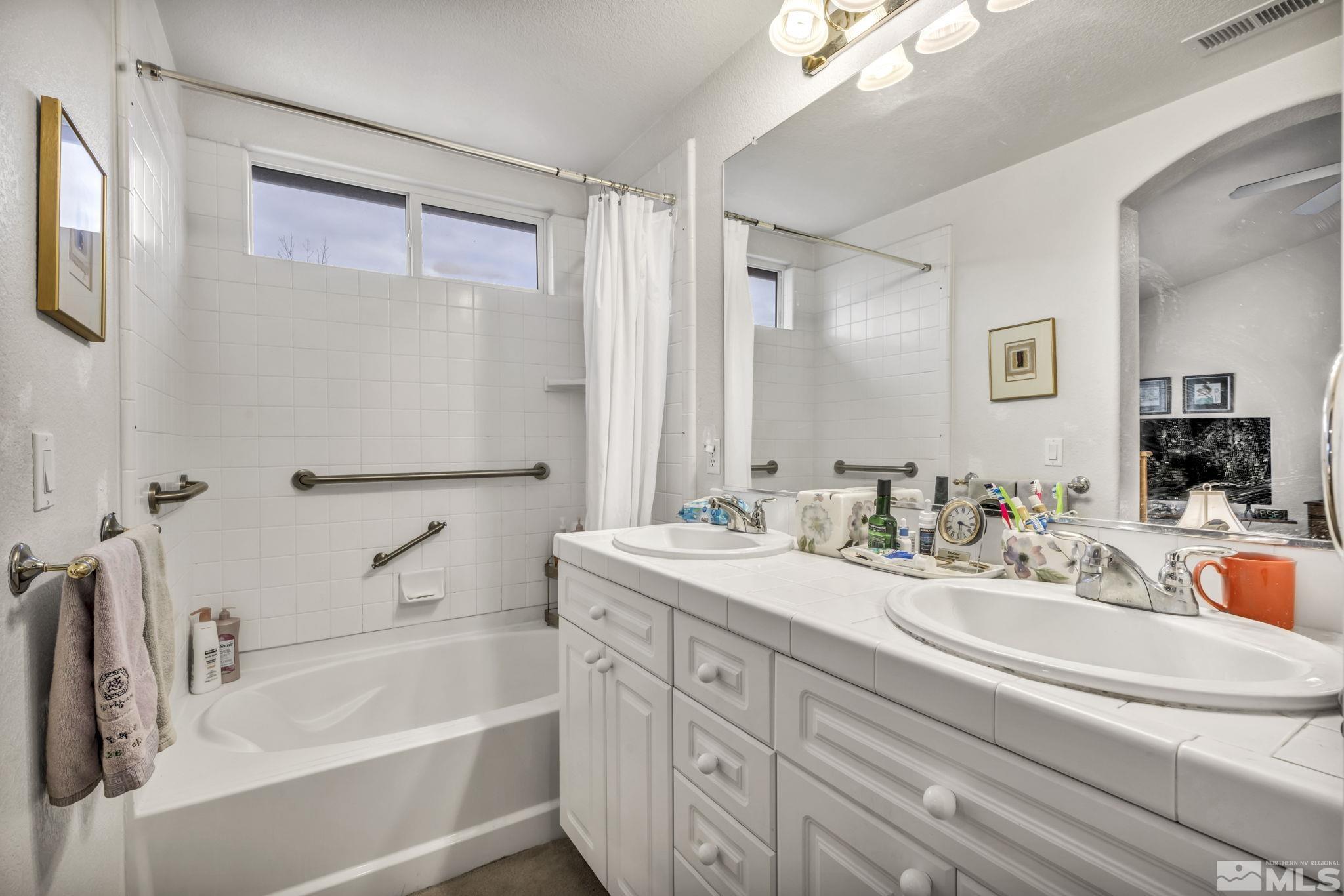 1770 Ornellaia Way Reno, NV 89521 - Photo 19 of 37 a bathroom with a tub a sink and mirror