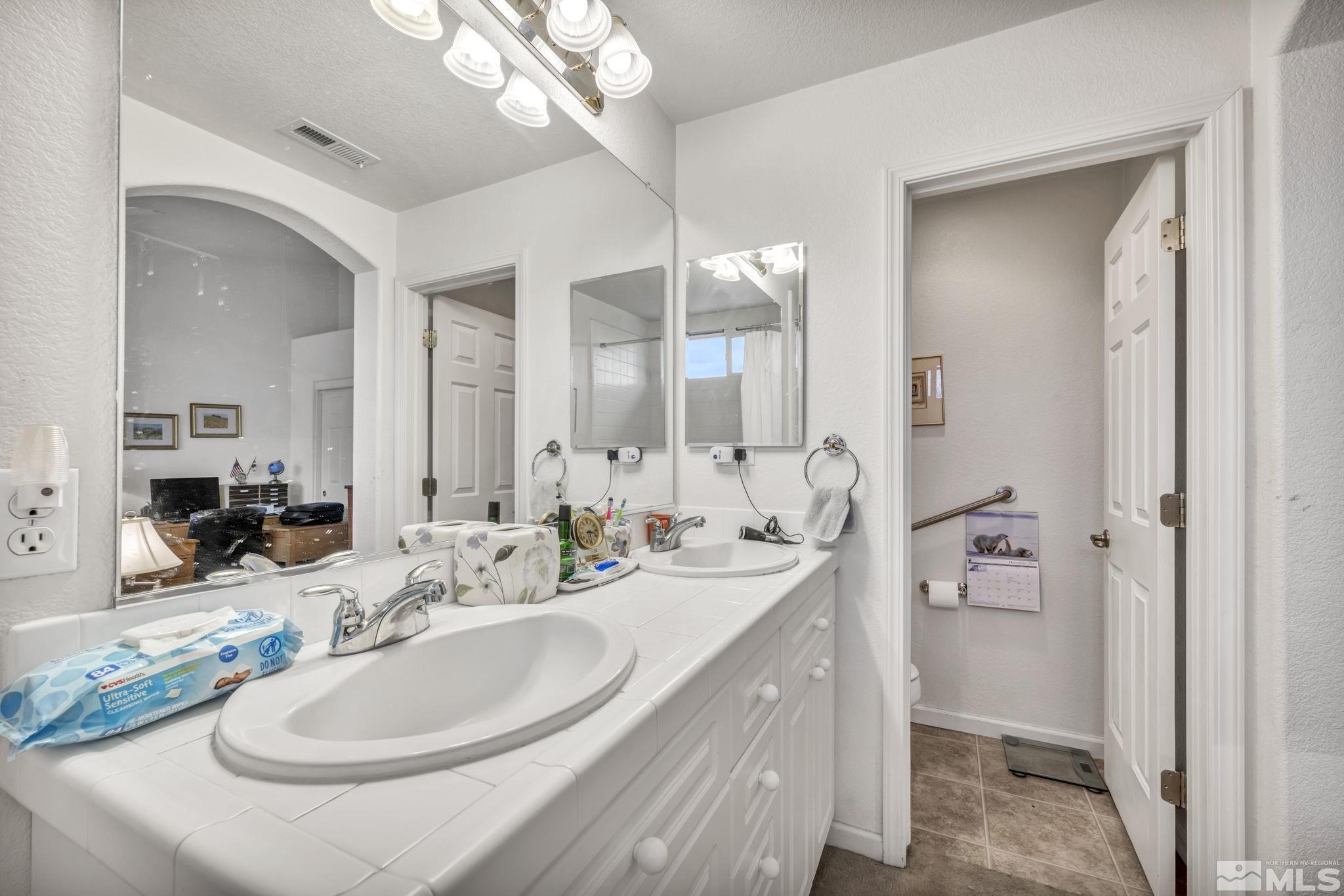 1770 Ornellaia Way Reno, NV 89521 - Photo 20 of 37 a bathroom with a double vanity sink and a mirror