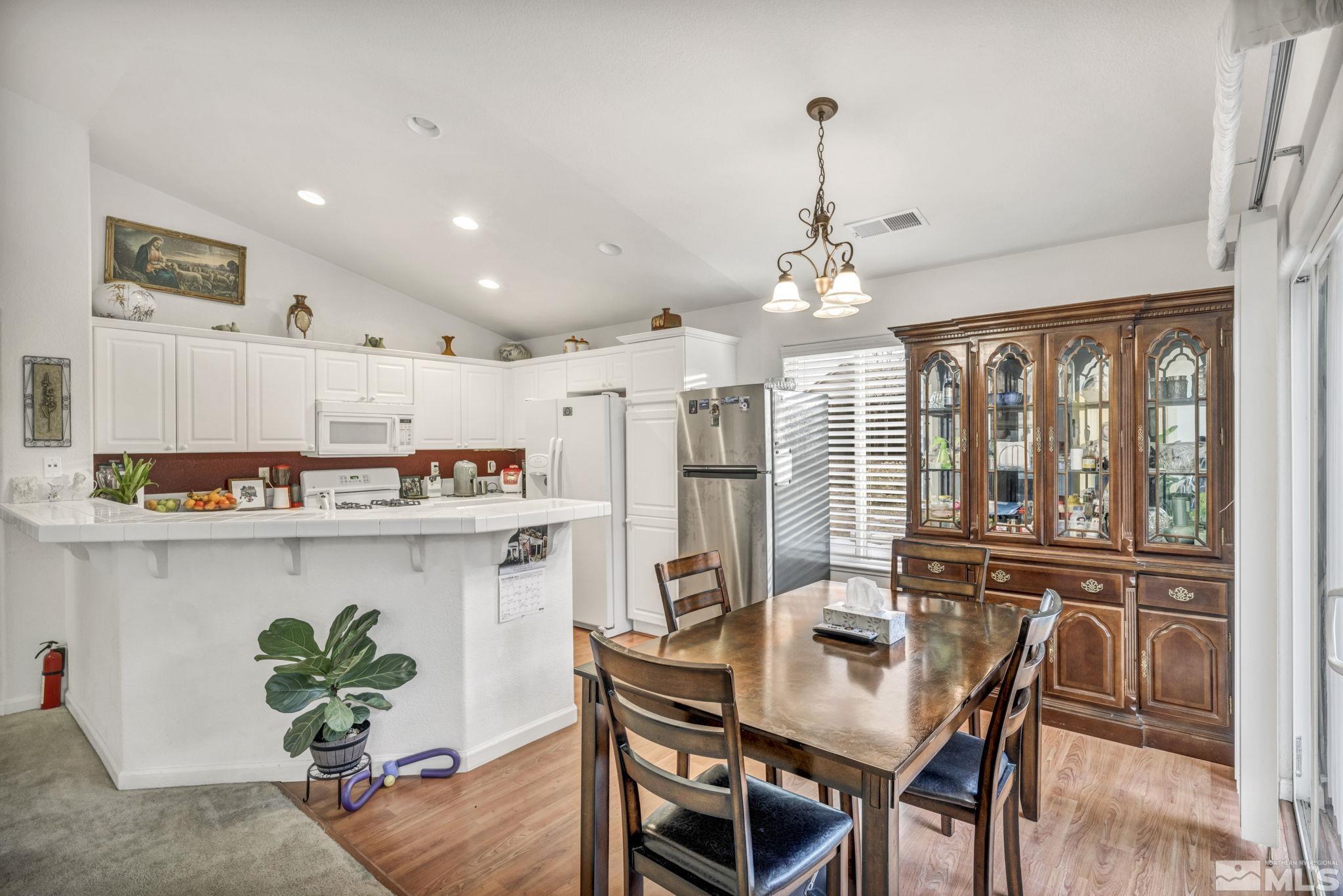 1770 Ornellaia Way Reno, NV 89521 - Photo 25 of 37 a view of a dining room with furniture window and wooden floor