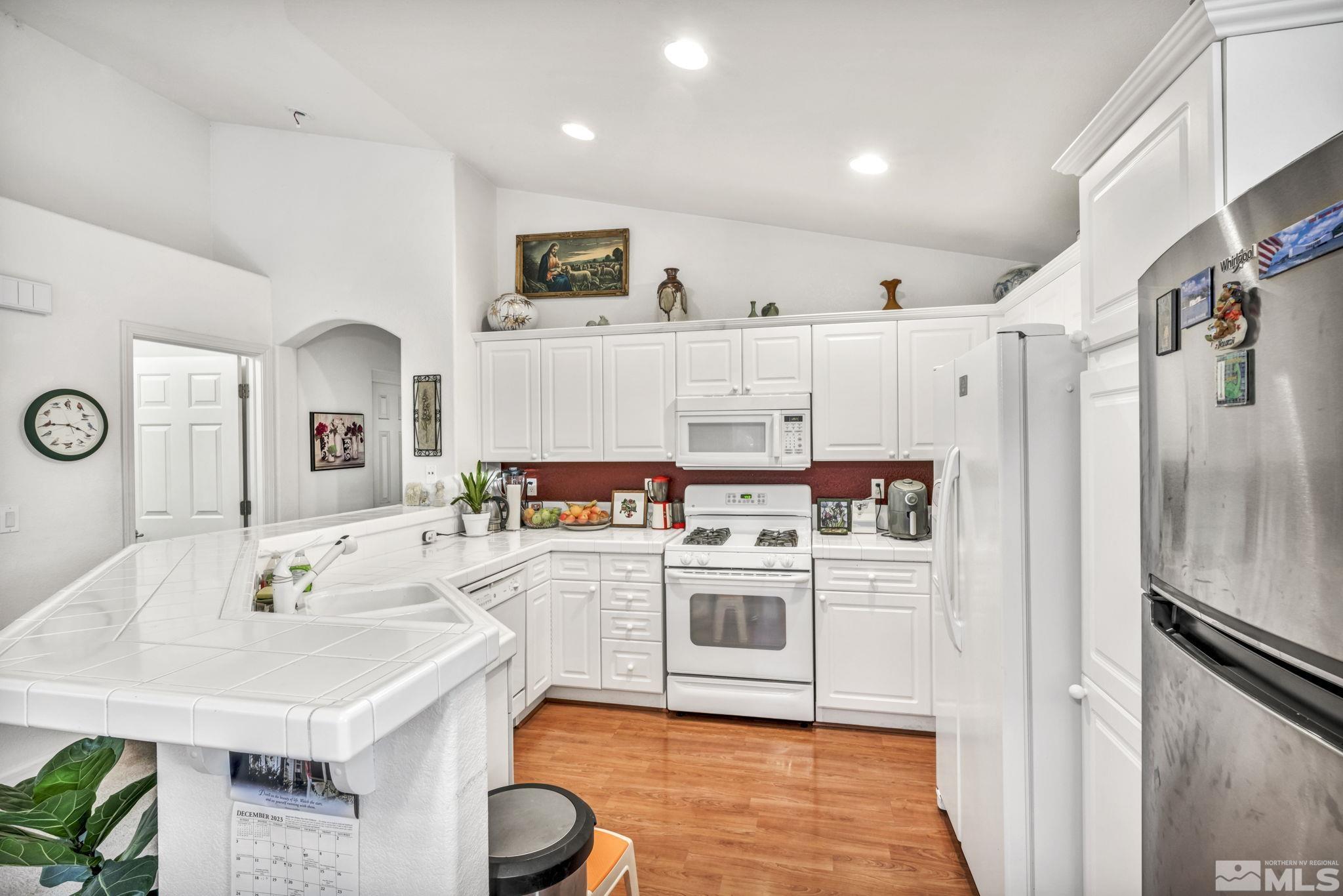 1770 Ornellaia Way Reno, NV 89521 - Photo 27 of 37 a kitchen with kitchen island a sink a stove and refrigerator