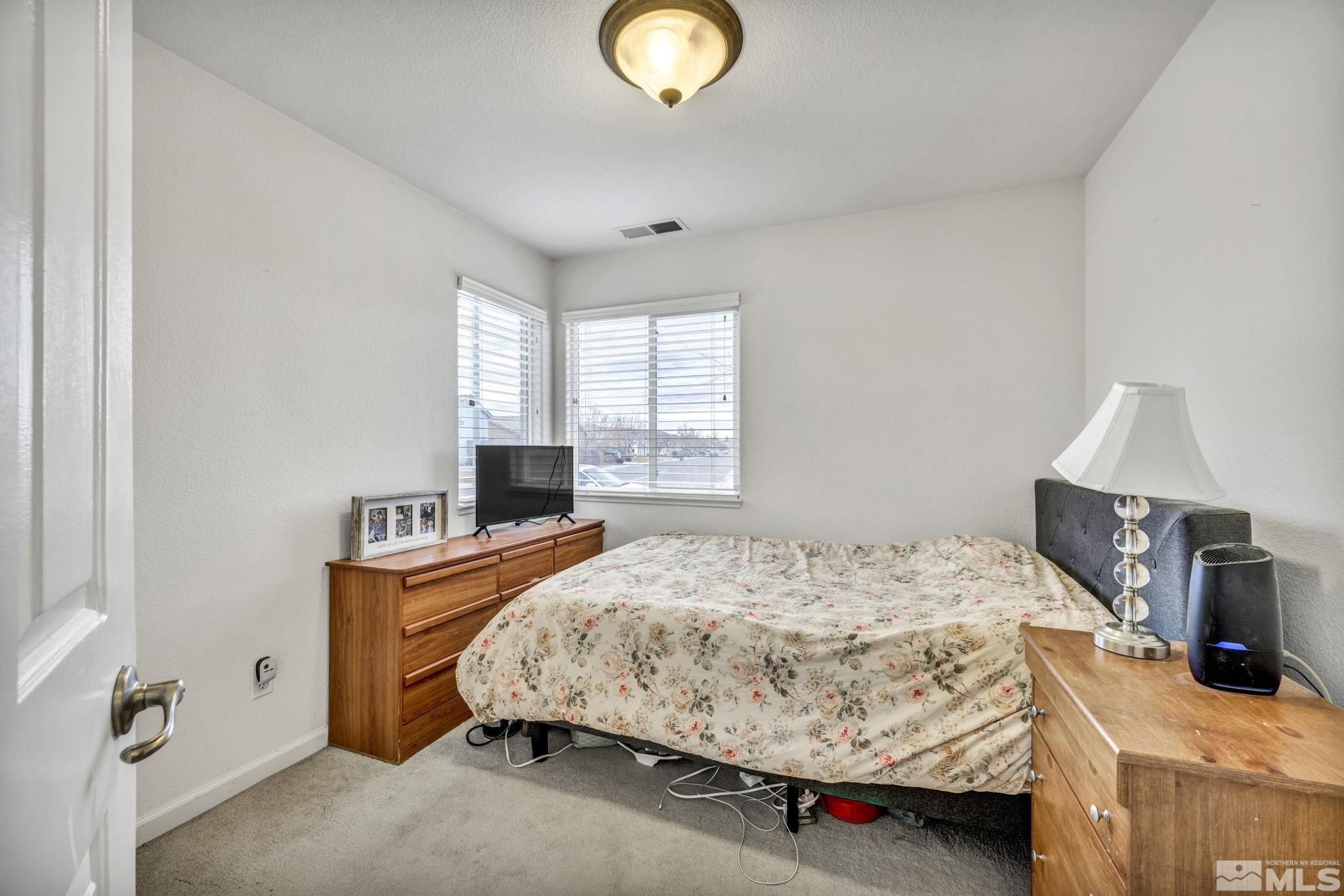 1770 Ornellaia Way Reno, NV 89521 - Photo 9 of 37 a bedroom with a bed and a lamp