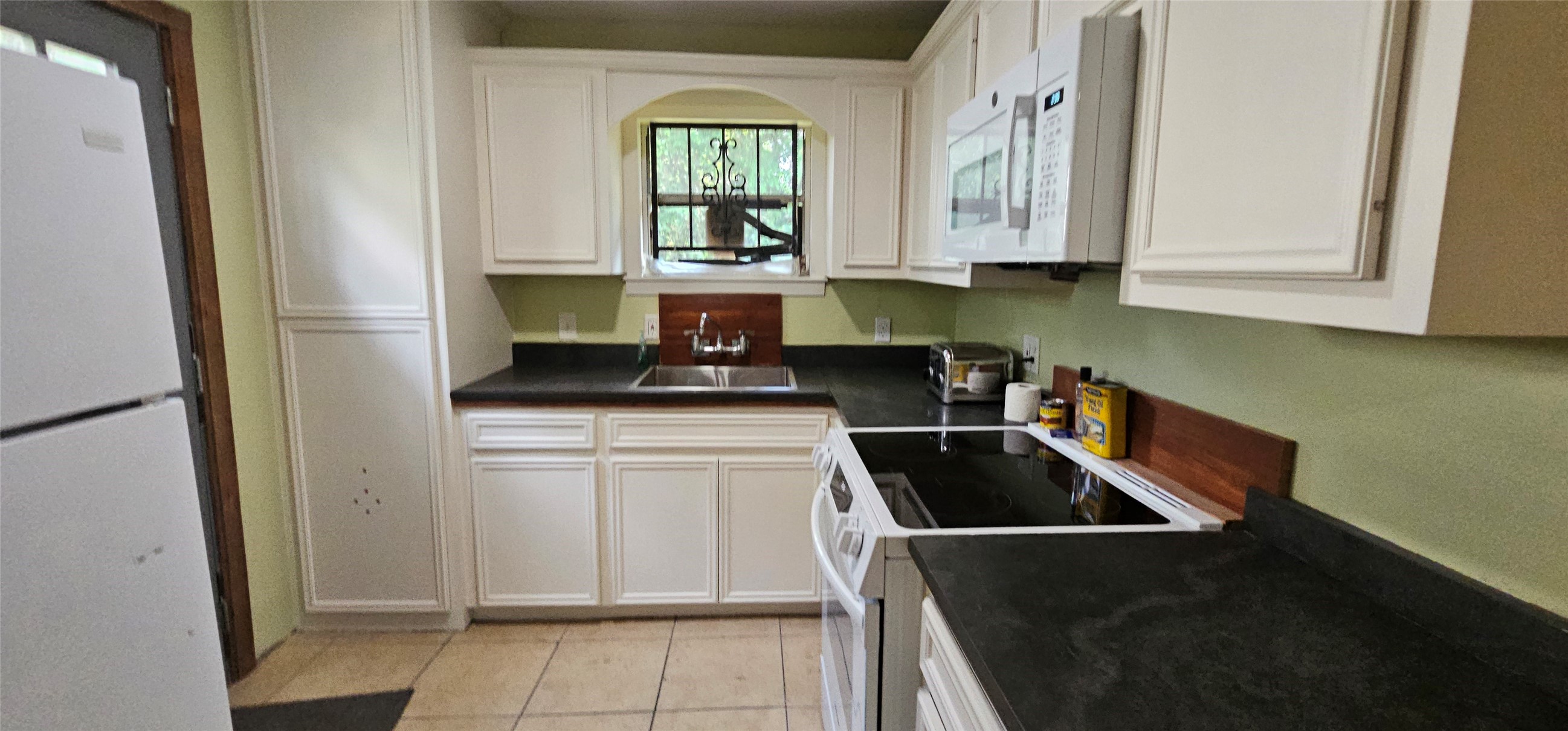 3610 Dennis Street Houston, TX 77004 - Photo 6 of 20 a kitchen with a refrigerator and a stove top oven