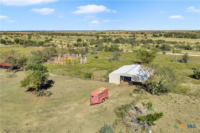 a living room with furniture a rug and a window