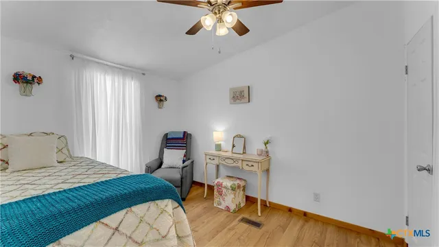 a bedroom with furniture and a flat screen tv