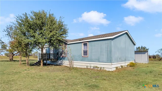 a view of a patio with a table and chairs under an umbrella