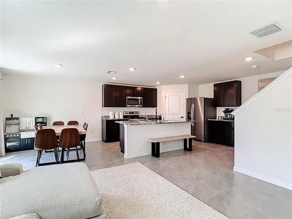 a living room with furniture and kitchen view