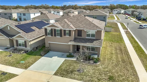 an aerial view of a house with a yard