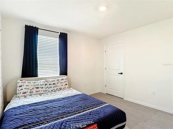 a bedroom with a bed and a cabinets