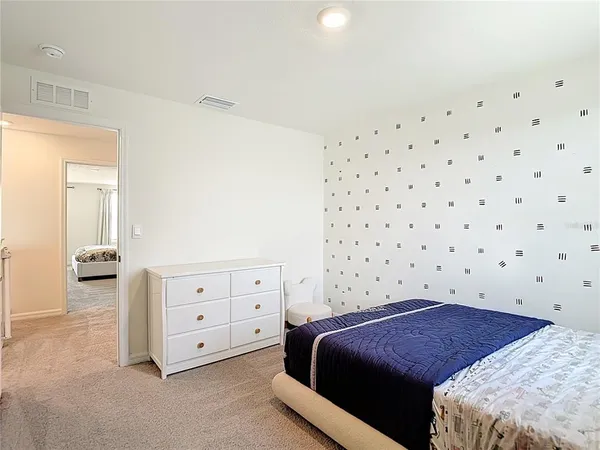 a bed sitting in a bedroom next to a window