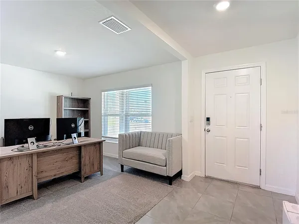 a view of a livingroom with workspace and a couch