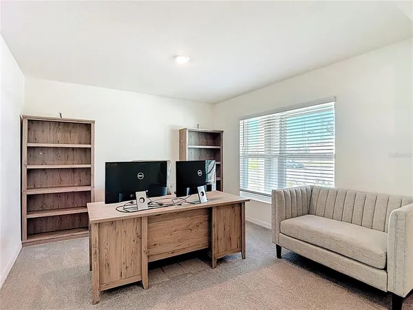 a view of living room with furniture and window