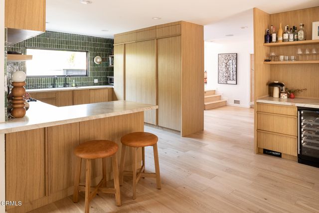 a large kitchen with granite countertop a counter space and cabinets