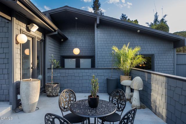 a view of a chairs and table in the patio